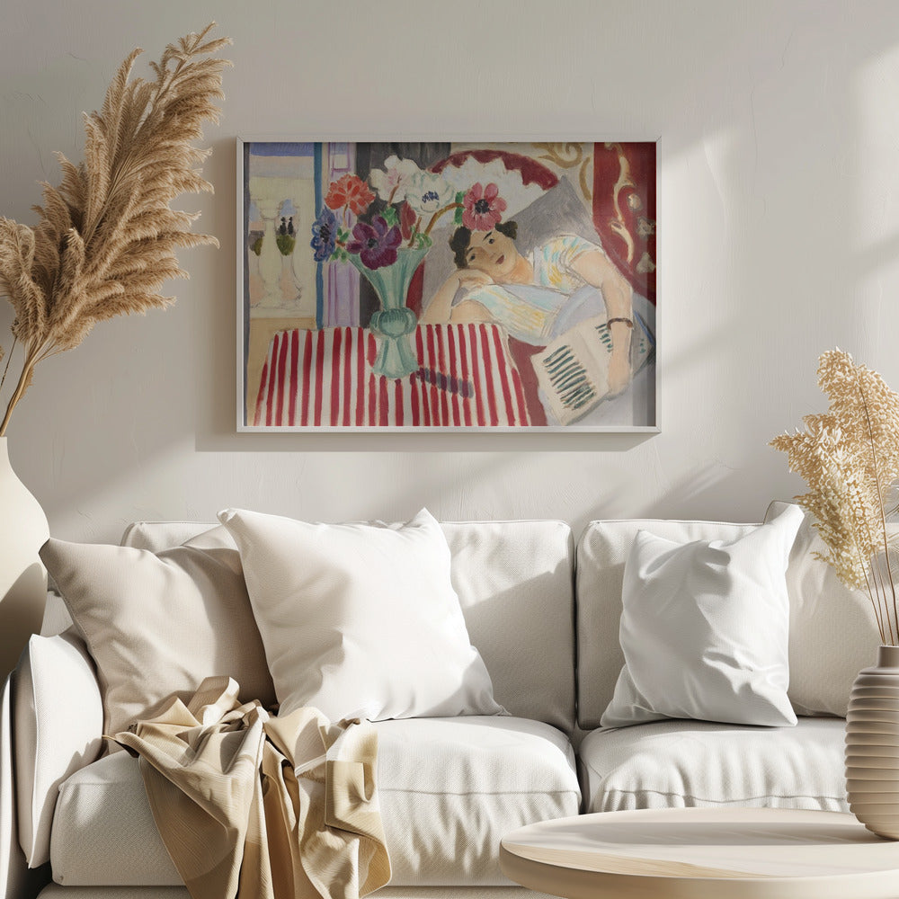 A Fauvist-style painting by Henri Matisse depicting a woman in a colorful blouse reclining with a book. Beside her is a table with a bold red-and-white striped cloth holding a light green vase with red, purple, and white anemone flowers. Print