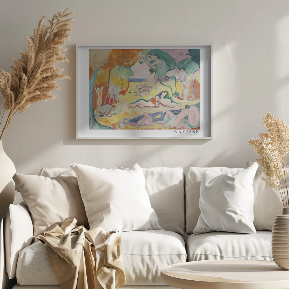 A framed art print of Henri Matisse's famous Fauvist painting, 'Le Bonheur de Vivre' (The Joy of Life). The colorful, idyllic landscape is filled with nude figures lounging, dancing, and playing music under vibrant yellow, orange, and green trees against a pink sky. Wall Art