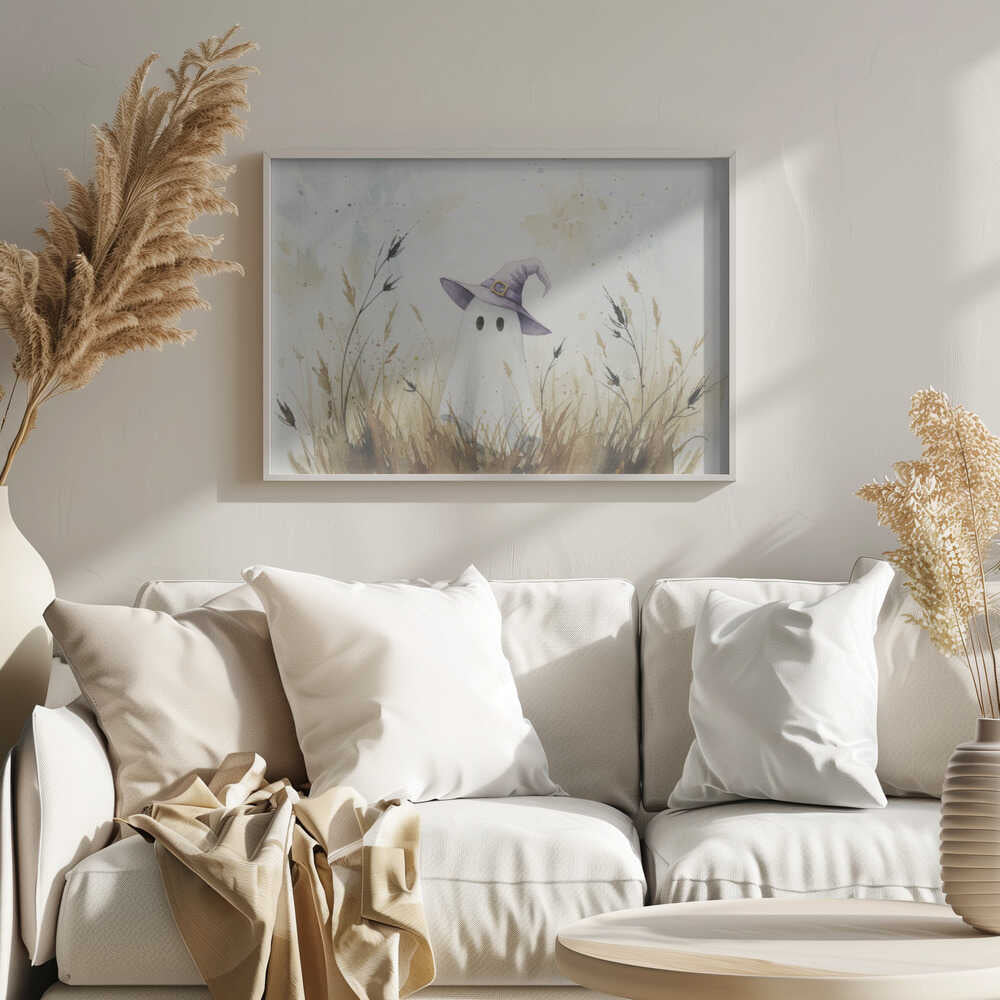 A whimsical watercolor painting of a cute white ghost wearing a purple witch's hat. The ghost is standing in a field of tall, dry brown and beige grasses against a light, splotchy background, all within a silver frame. Artwork