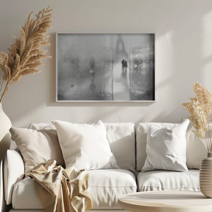 A framed, moody black and white photograph with a heavy blur effect, depicting a couple's silhouette walking towards the distant, hazy Eiffel Tower on what appears to be a rainy day in Paris. Artwork