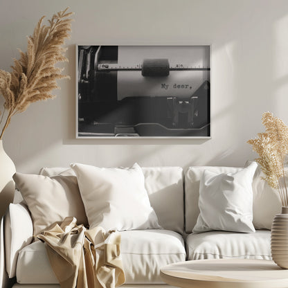 A close-up, black and white photograph of a vintage typewriter. A sheet of white paper is loaded, and the words 'My dear,' have just been typed, creating a sense of nostalgia and romance. The image is enclosed in a silver frame. Wall Art