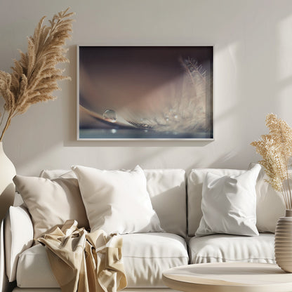 A serene macro photograph of a single, perfect water droplet resting on a delicate white feather. The background is a soft, warm gradient from dark to light brown, creating a peaceful and fragile mood. Artwork