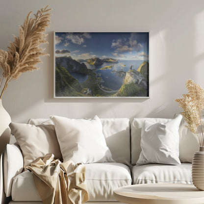 A breathtaking panoramic photograph of the Lofoten Islands in Norway from a high vantage point. A person stands on a rocky cliff with arms outstretched, overlooking a stunning landscape of deep blue fjords, lush green mountains, and the small fishing village of Reine below. The sky is a vibrant blue with scattered white clouds. Artwork