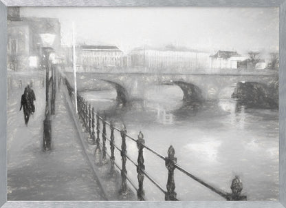 A framed, black and white impressionistic artwork of a city scene on a foggy or rainy day. In the foreground, a dark metal railing runs along a riverside walkway where a person in a dark coat is walking. An arched stone bridge crosses the river in the midground, with hazy buildings visible in the background, creating a moody and atmospheric scene. Wall Art