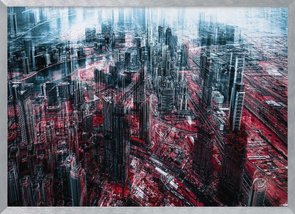 An abstract, digitally manipulated aerial photograph of a dense, futuristic cityscape. The image features towering skyscrapers in cool blue and dark gray tones, while the streets and ground below are saturated in a vibrant, contrasting red. The artwork has a glitchy, multi-exposure effect, creating a sense of dynamic chaos, and is enclosed in a silver frame. Artwork