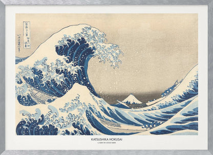 A framed print of Katsushika Hokusai's famous woodblock artwork, 'The Great Wave off Kanagawa,' featuring a giant, turbulent blue wave with white foam cresting over small boats, with Mount Fuji visible in the background under a muted sky. Wall Art