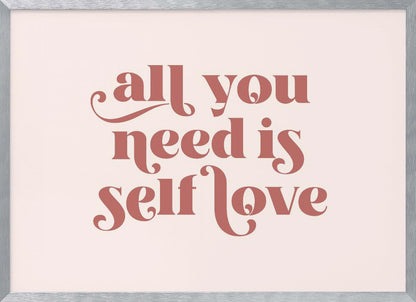 A framed art print with the phrase 'all you need is self love' in a stylish, dusty rose serif font on a light pink background. The artwork is enclosed in a simple silver frame. Poster