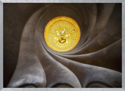 A worm's-eye view of an ornate, golden chandelier set against a swirling, textured dark grey ceiling. The spiraling architectural feature draws the eye to the brightly lit fixture, creating an abstract and dramatic composition. Poster