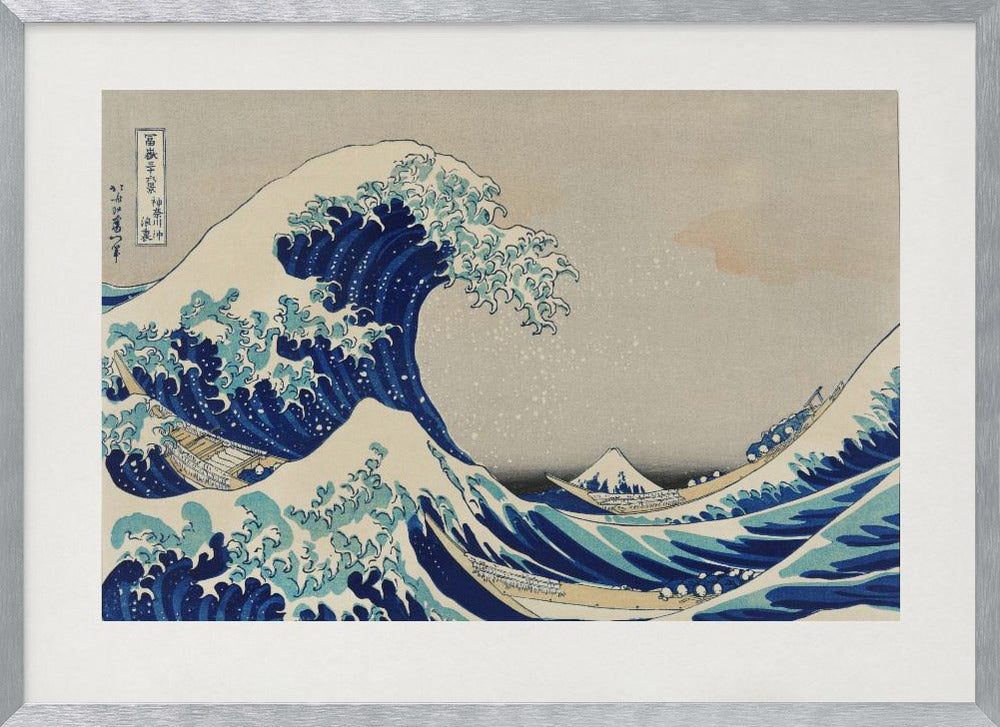 The Great Wave off Kanagawa by Hokusai, a framed Japanese woodblock print depicting a giant, menacing blue and white wave cresting over three boats, with a small Mount Fuji visible in the background under a muted, overcast sky. Artwork