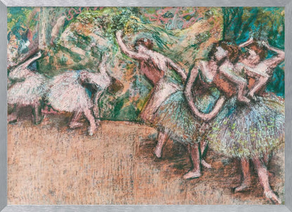 An Impressionist painting by Edgar Degas of ballet dancers on a stage against a green and orange backdrop. The dancers, in various poses, wear tutus in shades of white, pink, and light green. The artwork is framed in a simple silver frame. Artwork