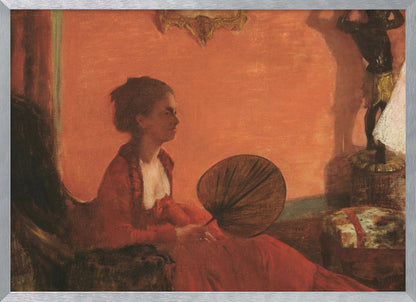 A vintage painting of a woman in profile sitting in a chair against a warm, orange-toned wall. She is wearing a red dress with a white ruffled collar and holding a dark, circular fan in her lap. The room is softly lit, with shadows and a small statue visible in the background. Wall Art
