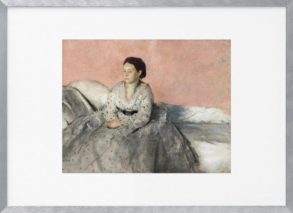 A framed impressionist painting of a woman with dark hair sitting on a bed against a dusty rose background. She wears a white, dotted blouse and a voluminous gray skirt, looking thoughtfully to her left. The painting is set in a silver frame with a white mat. Poster