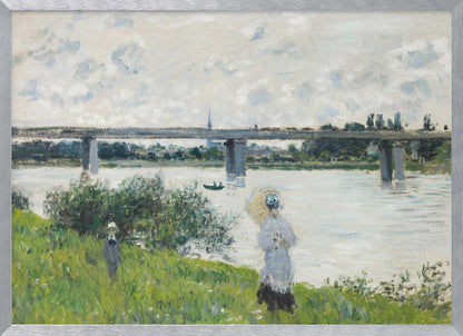 A scenic landscape art print by Claude Monet titled 'The Promenade With the Railroad Bridge, Argenteuil', depicting people on a promenade alongside a body of water with a railroad bridge in the background, characteristic of Impressionist style with soft colors and brushstrokes. Print