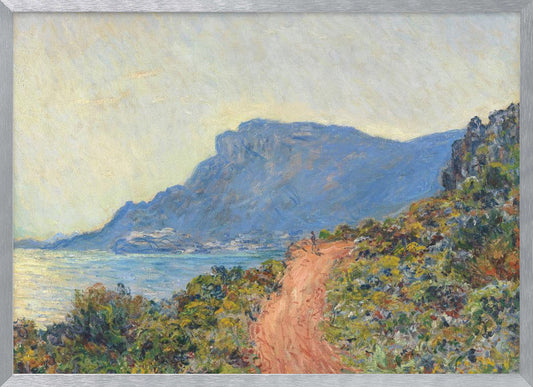 An Impressionist painting by Claude Monet titled 'Cap Martin, near Menton', depicting a sunlit coastal scene. A reddish-brown path winds along a vibrant, brush-covered cliff in the foreground, overlooking the blue Mediterranean Sea. A large, hazy blue mountain dominates the background under a pale yellow sky. Decor
