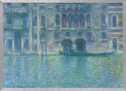 An Impressionist painting by Claude Monet titled 'The Palazzo Contarini,' depicting a grand Venetian building from across a canal. The artwork is characterized by hazy, blended brushstrokes in a cool palette of blues, greens, and purples, creating a misty and atmospheric effect on the water and architecture. A single gondola is moored near the building's entrance. The painting is displayed within a silver frame. Decor