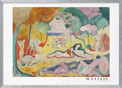A framed art print of Henri Matisse's famous Fauvist painting, 'Le Bonheur de Vivre' (The Joy of Life). The colorful, idyllic landscape is filled with nude figures lounging, dancing, and playing music under vibrant yellow, orange, and green trees against a pink sky. Wall Art