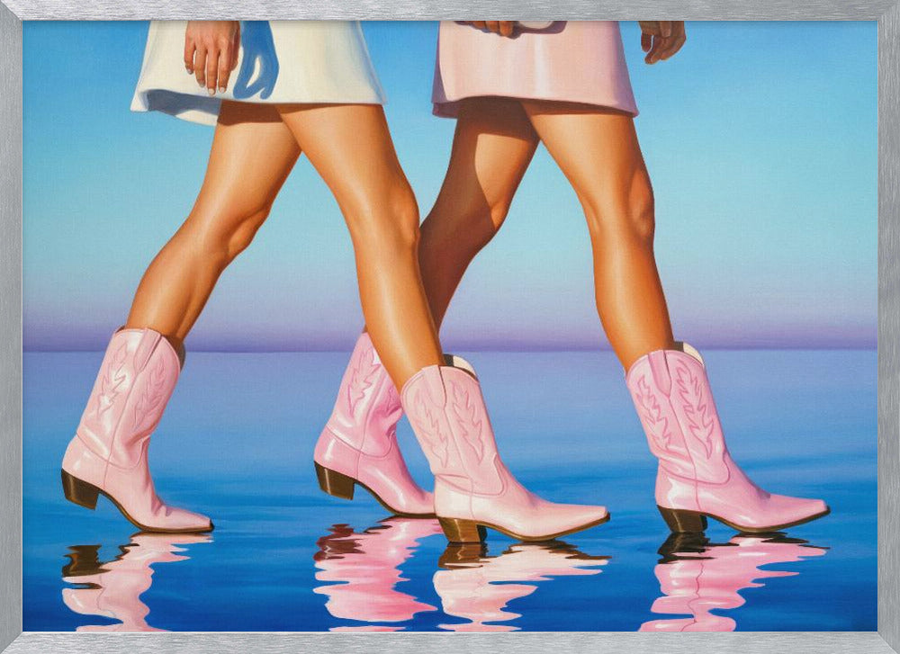 A pop art style painting of the legs of two women wearing matching pink cowboy boots and short skirts, walking across a reflective blue surface that mirrors their steps. The background is a gradient of blue and lavender, and the entire image is contained within a silver frame. Wall Art