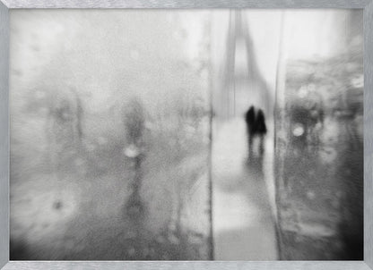 A framed, moody black and white photograph with a heavy blur effect, depicting a couple's silhouette walking towards the distant, hazy Eiffel Tower on what appears to be a rainy day in Paris. Artwork