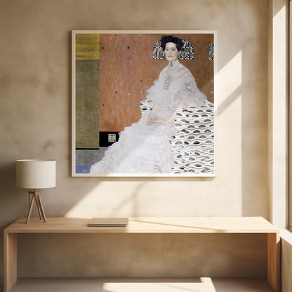 A framed print of Gustav Klimt's 'Portrait of Fritza Riedler'. A woman with dark upswept hair wearing a flowing white gown sits in a patterned armchair against a geometric, earth-toned background. Decor
