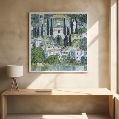 A framed art print of Gustav Klimt's 'Church in Cassone,' featuring a dense, colorful depiction of a hillside village by a lake. The scene is filled with white-walled houses, tall cypress trees, and lush greenery, all painted in a distinctive, textured, mosaic-like style with dominant blues, greens, and yellows. Decor