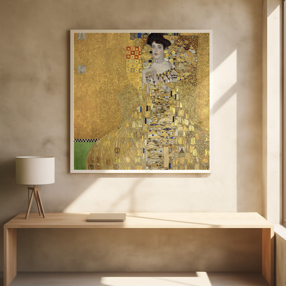 A framed print of Gustav Klimt's 'Portrait of Adele Bloch-Bauer I,' also known as 'The Woman in Gold.' The painting depicts a woman in an ornate, gilded gown covered in intricate patterns, blending into a shimmering gold background characteristic of the Art Nouveau style. Poster