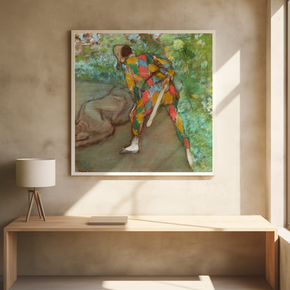 A pastel painting by Edgar Degas titled 'Harlequin'. It shows a figure from behind, dressed in a colorful diamond-patterned harlequin costume of red, yellow, green, and blue. The figure is bent over in a grassy landscape, holding a bat or slapstick. The style is impressionistic and soft. Print