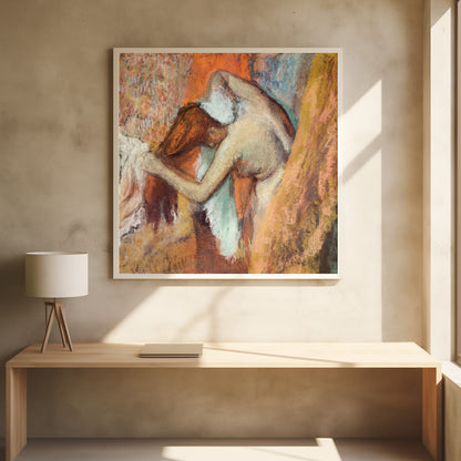 A framed impressionist pastel drawing by Edgar Degas showing a nude woman from the back, bending over to dry her neck with a towel. The artwork is characterized by its warm color palette of oranges, browns, and yellows, with textured, visible strokes. Decor