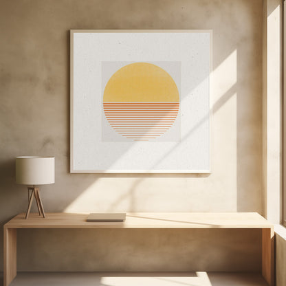 A framed minimalist art print featuring a large circle against an off-white background. The top half of the circle is a solid textured yellow, while the bottom half consists of horizontal orange stripes that gradually become thinner towards the bottom, evoking a stylized sun or sunset. The artwork is surrounded by a wide white mat and a light wood frame. Decor