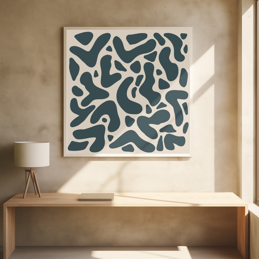 A square abstract art print in a light wood frame, showcasing a pattern of dark teal, amoeba-like shapes scattered on a light beige background. Print